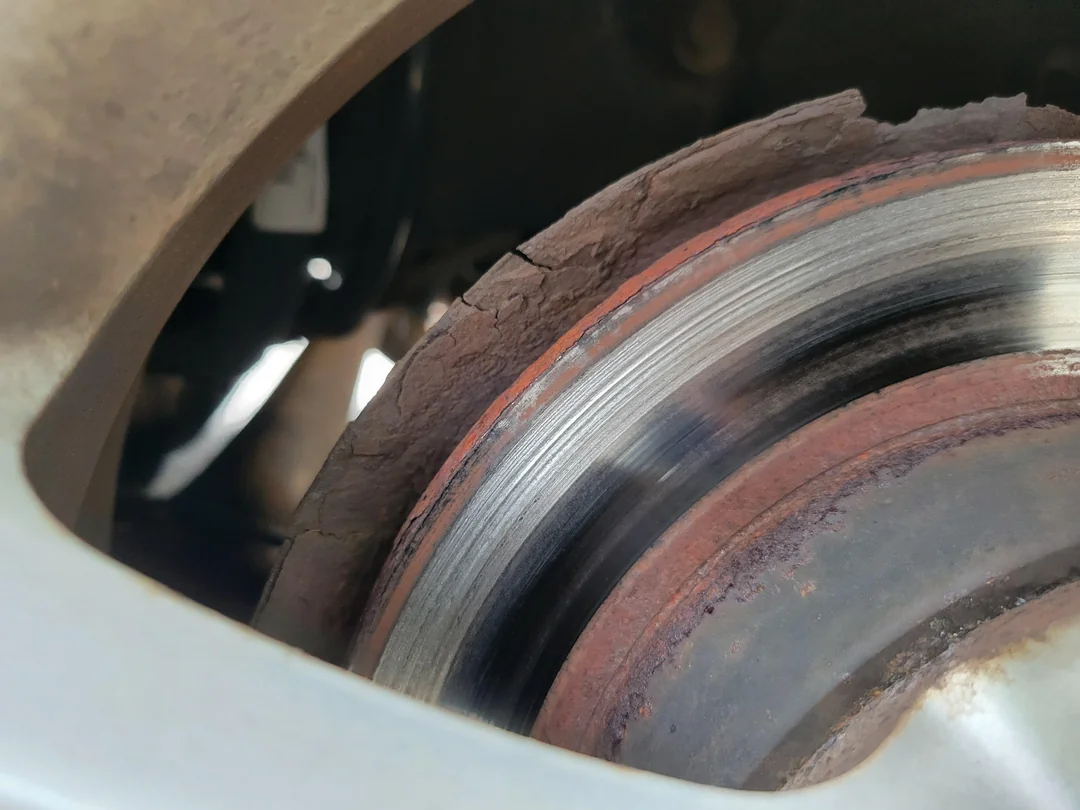 Brake pads and brake rotor being inspected
